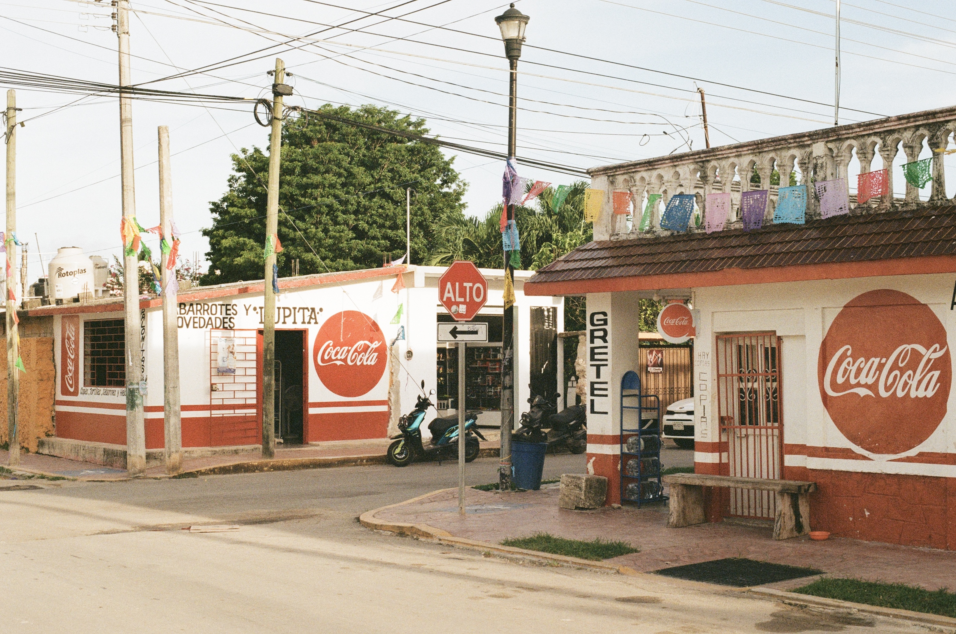Shops covered in Coca-Cola branding in Baccalar, Mexico